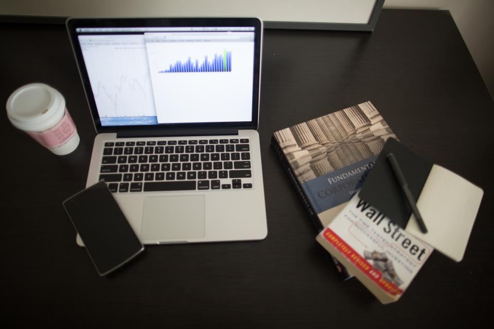 Laptop displaying data charts and financial graphs